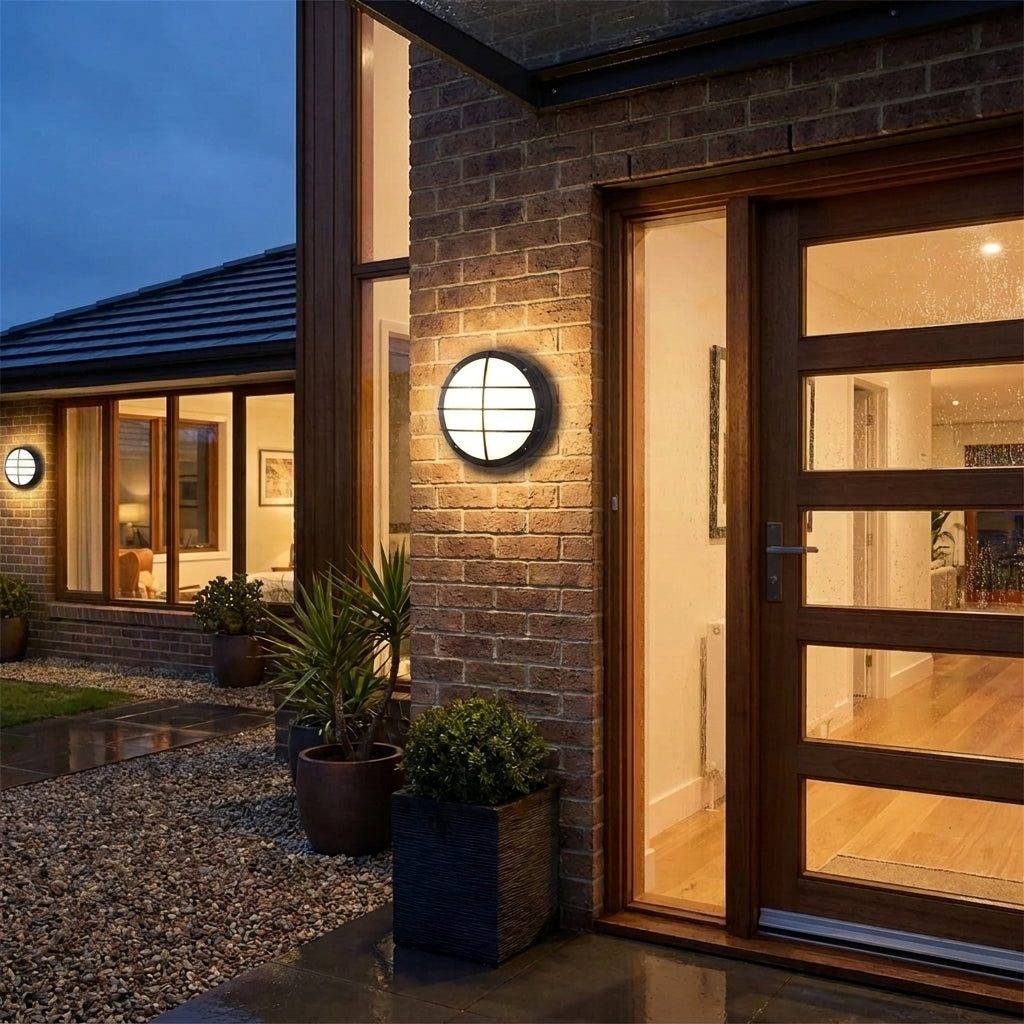 Byrzi outdoor wall light illuminating an entrance to the house