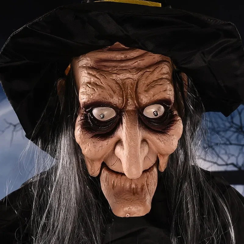 Cacklepost hanging witch prop displayed on a porch with seasonal Halloween decor