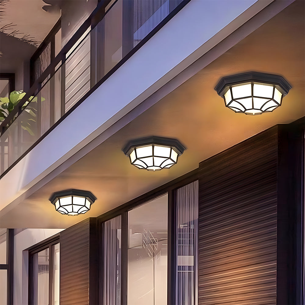 Row of black industrial cila outdoor ceiling lights illuminating a modern balcony walkway