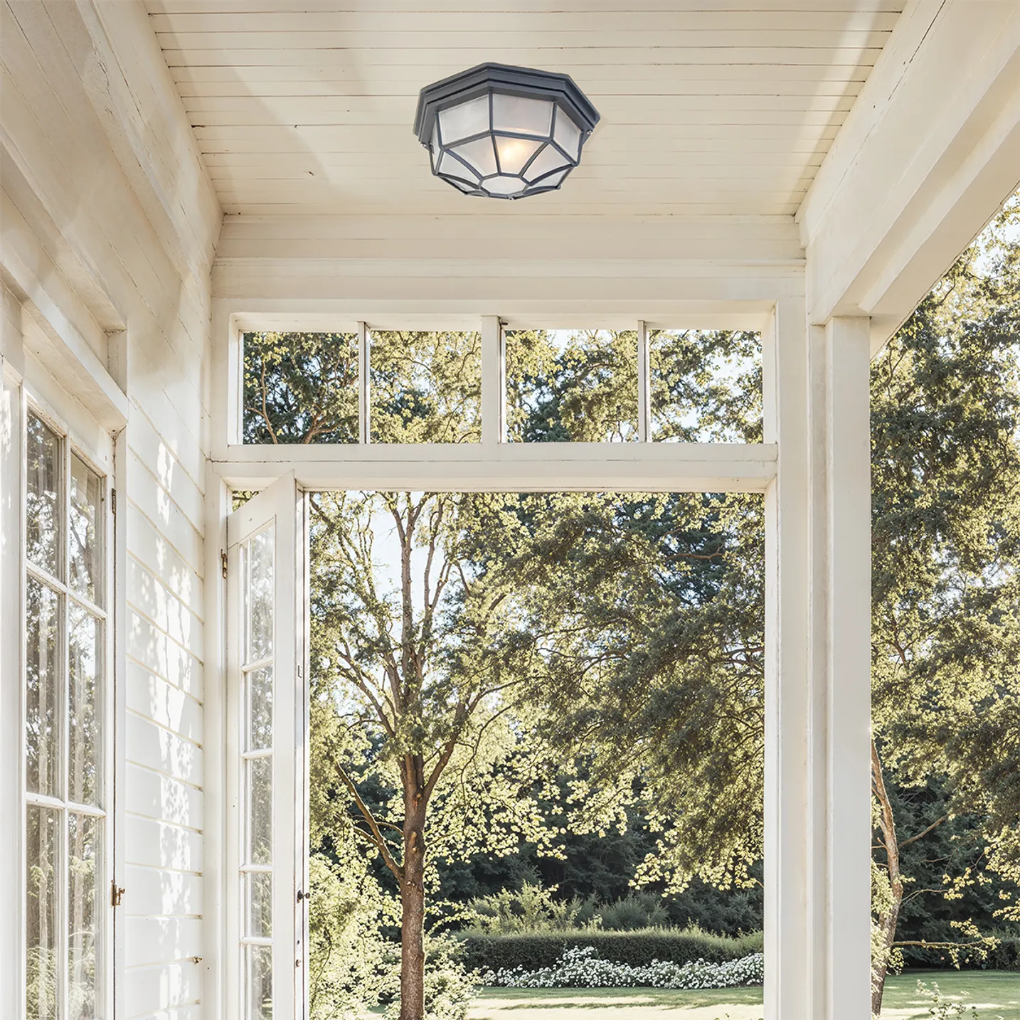 cila black rustic outdoor bulkhead ceiling light installed on a white covered porch