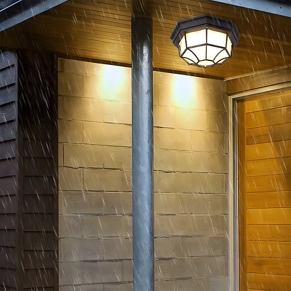 IP65 waterproof cila nautical wall sconce illuminated during heavy rain on an exterior column