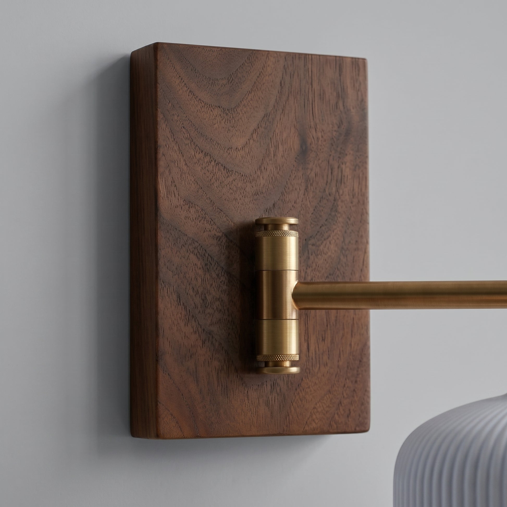 Close-up of Cizqa's walnut wall canopy and copper swing arm