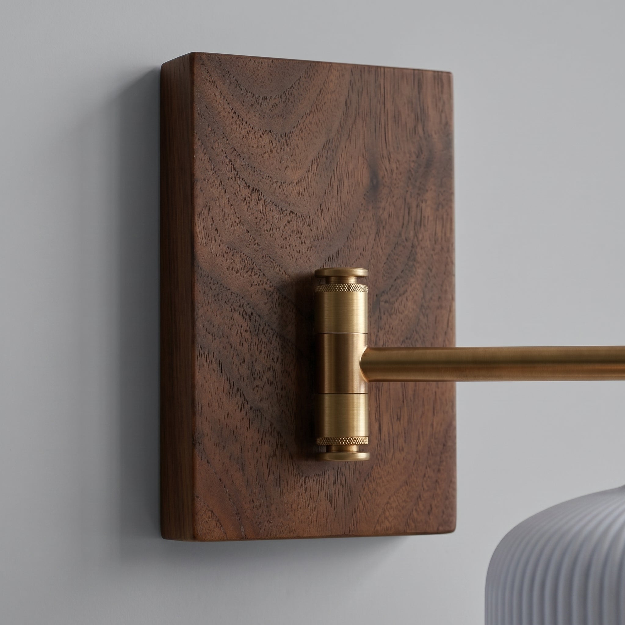 Close-up of Cizqa's walnut wall canopy and copper swing arm
