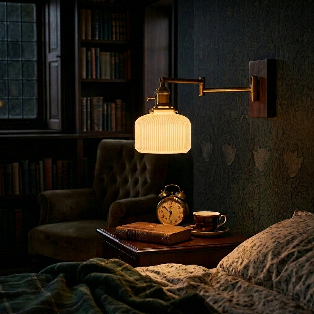 Cizqa wall light illuminated above a side table next to bed 