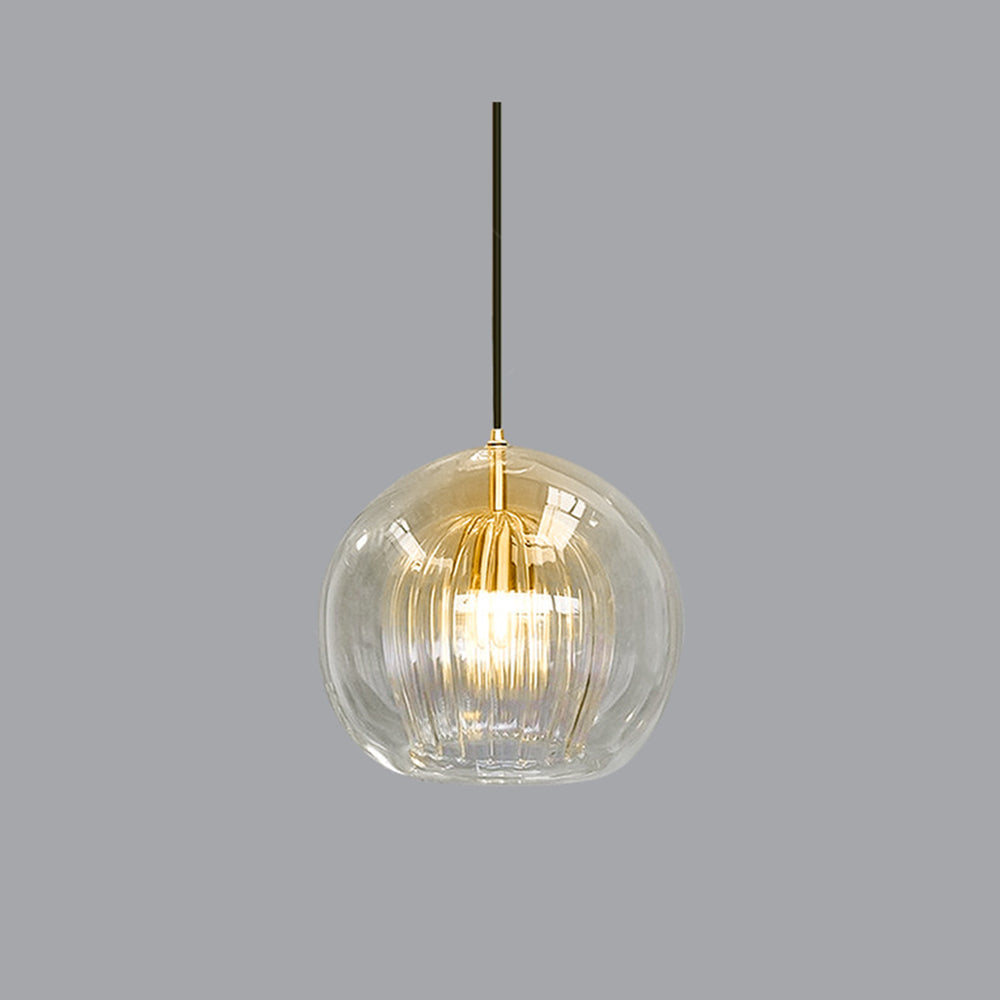 Illuminated clear double-layer glass pendant highlighting the warm glow of its fluted inner shade
