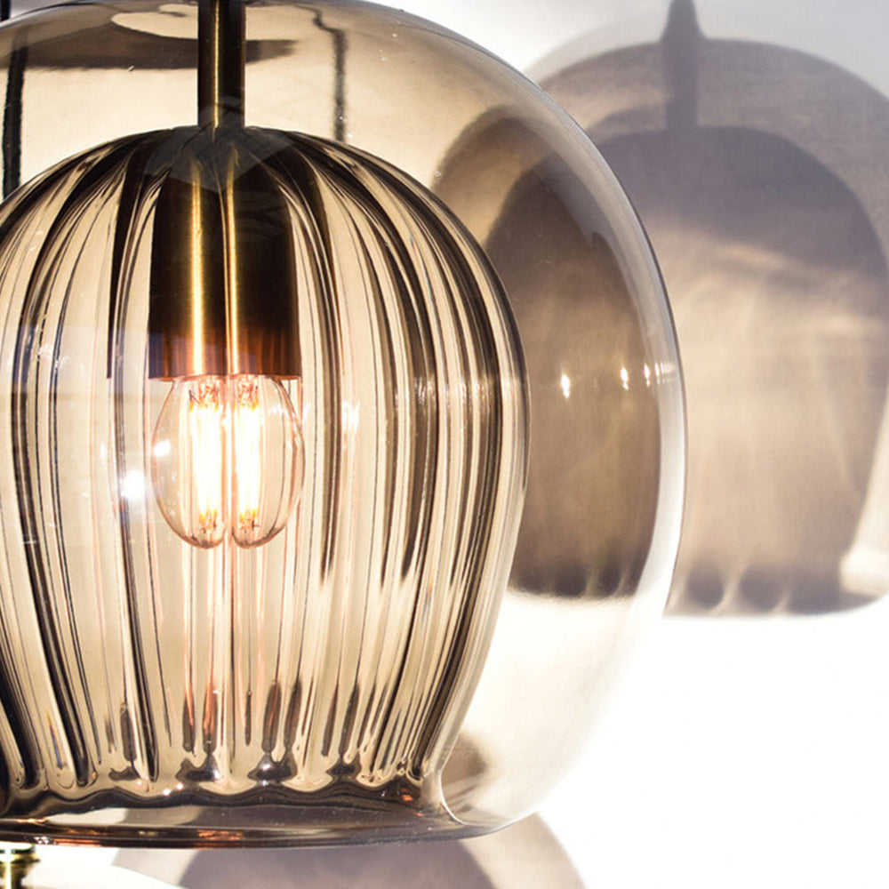 Close-up detail of the amber double-layer pendant showing the textured ribbed inner glass