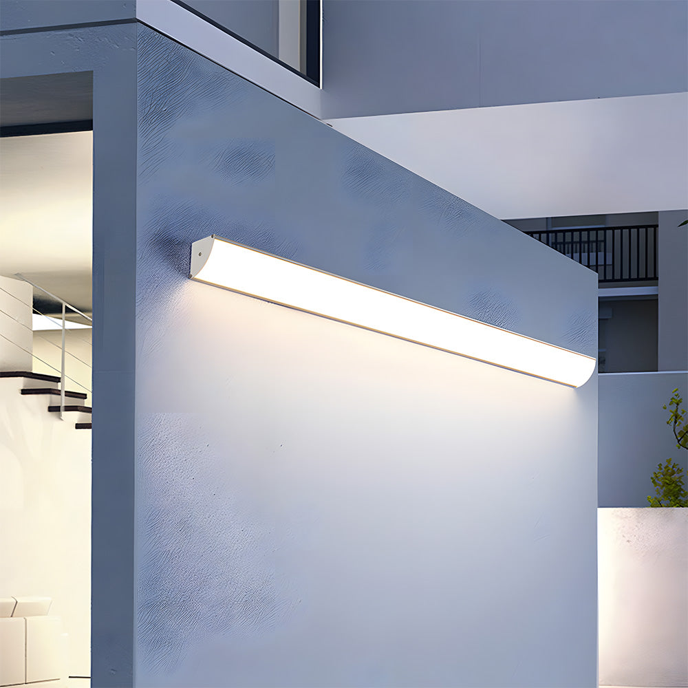 Angled close-up of a glowing front-lit linear wall lamp showcasing its seamless acrylic diffuser