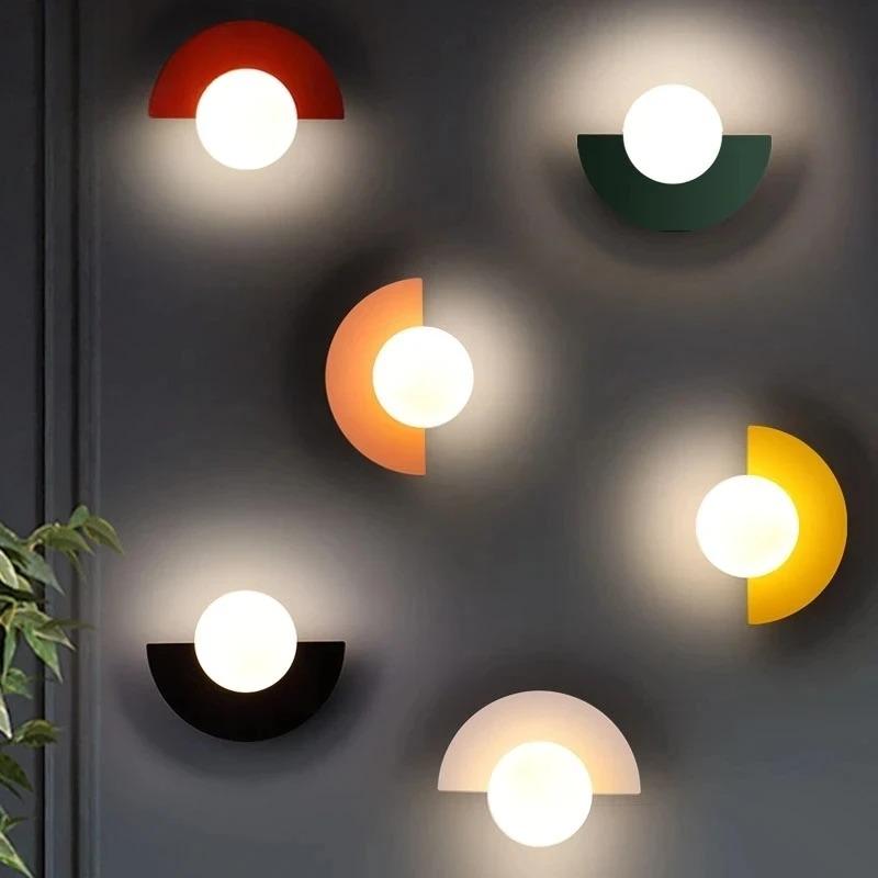 Dynamic cluster of colourful geometric wall sconces in white, orange, green, black, red, and yellow
