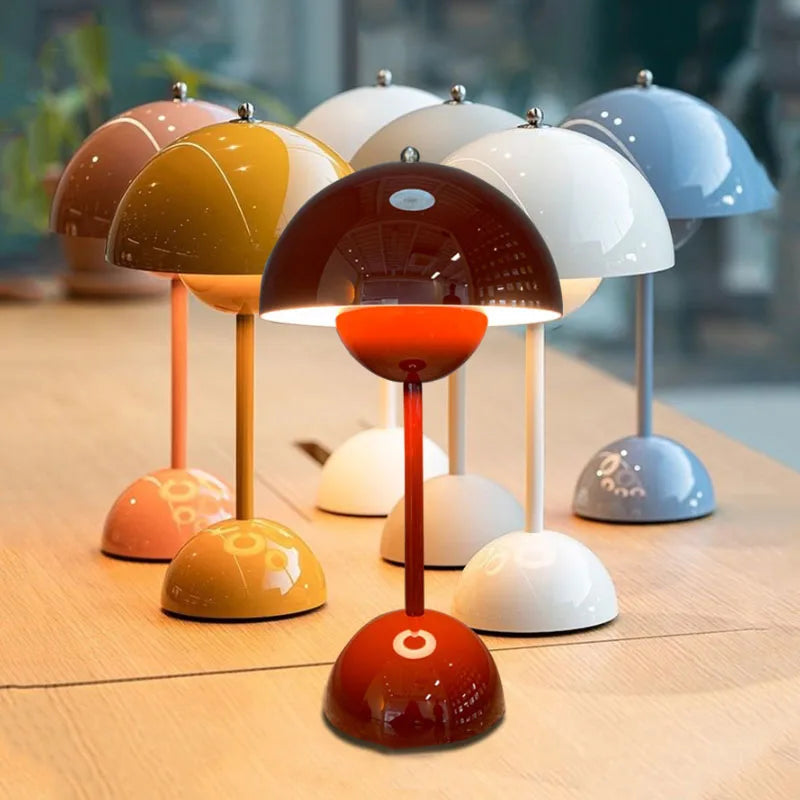 Collection of vibrant macaron-coloured cordless mushroom table lamps arranged together