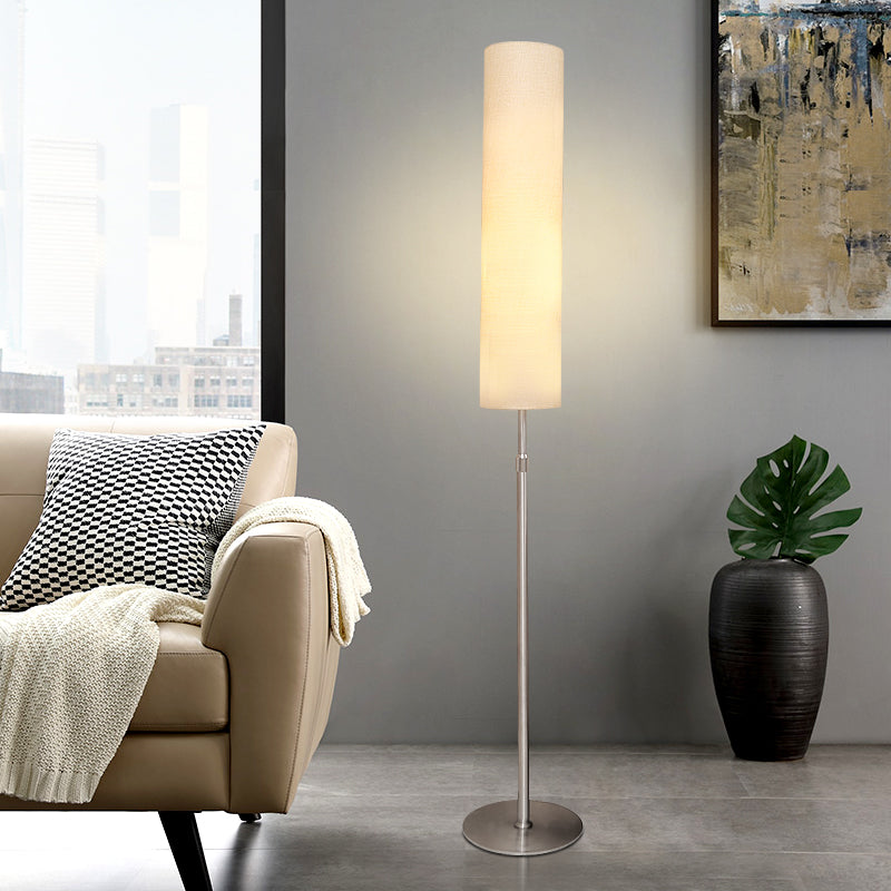 Contemporary white fabric floor lamp styled next to a beige sofa in a bright, modern interior
