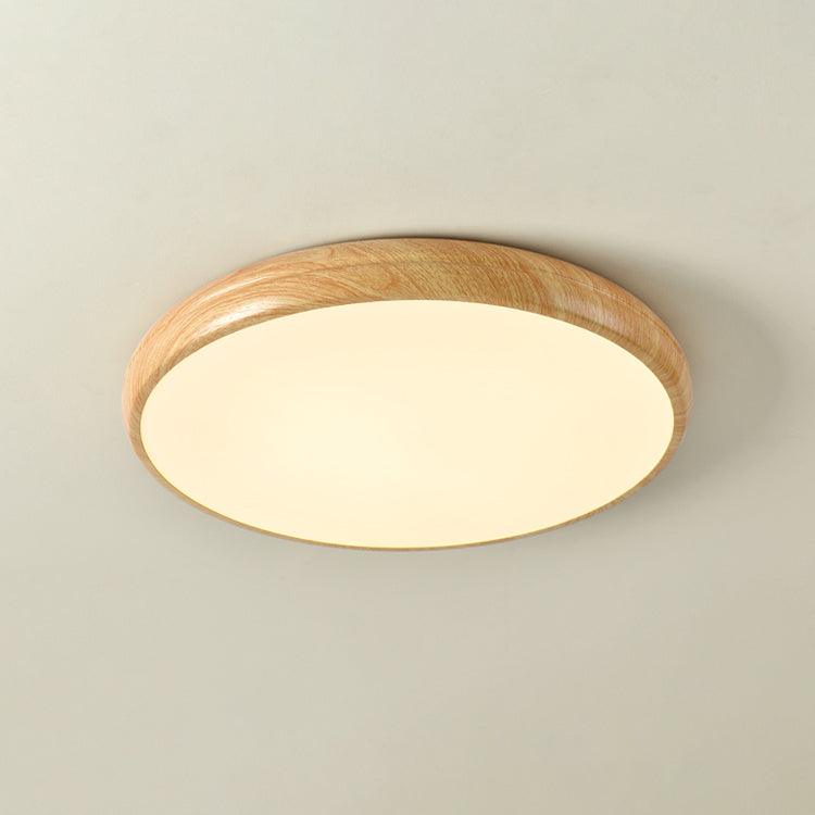 Angled view of the curved light oak wood-effect flush mount ceiling light