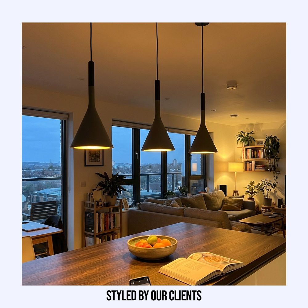 Customer styled graphite funnel pendants providing warm kitchen island lighting at twilight