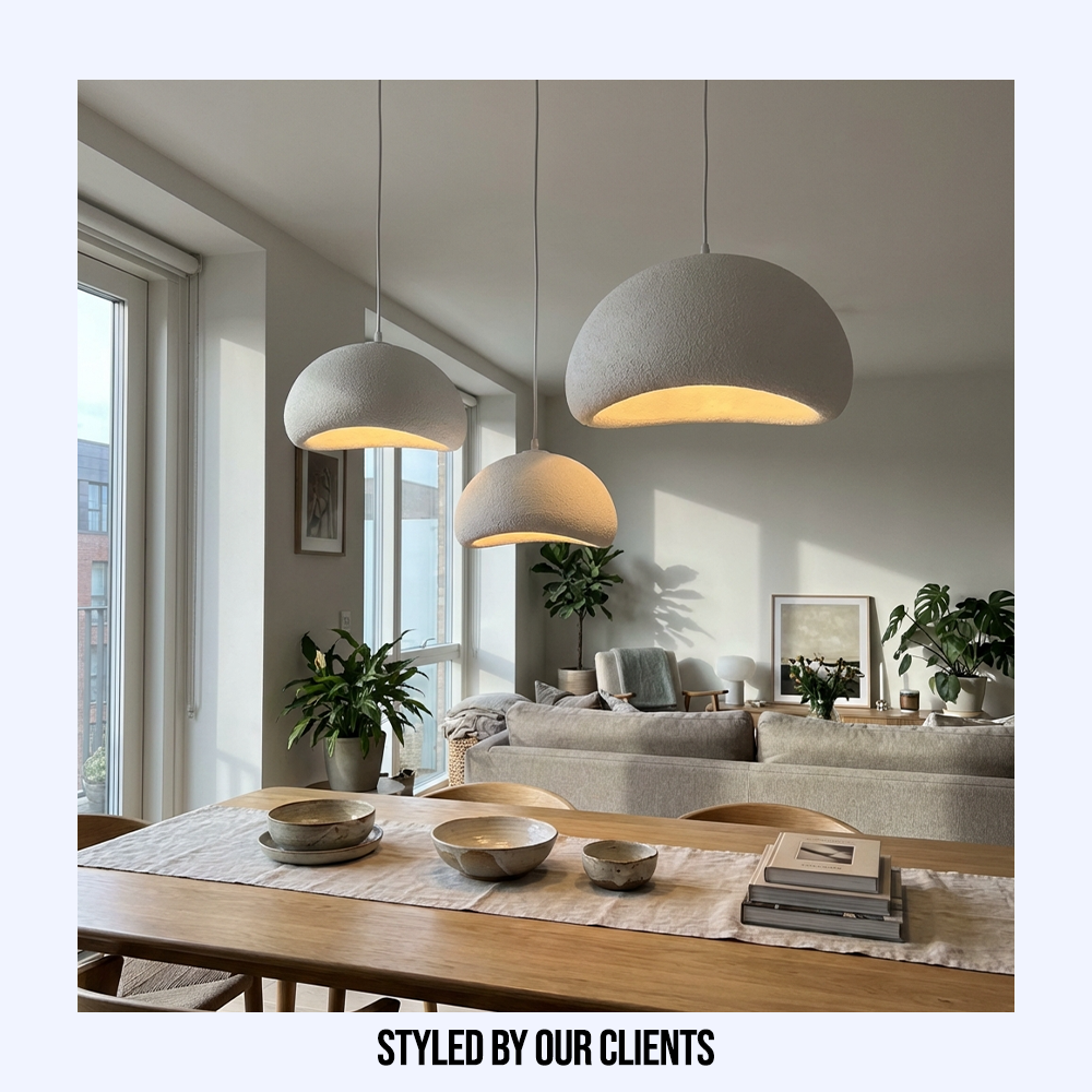 Customer styled cluster of white resin pendant lights hanging above a contemporary dining table