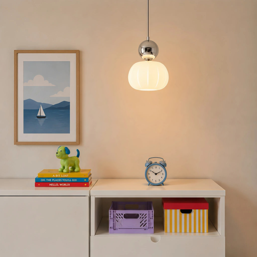 Silver chrome debz geometric pendant light hanging above a minimalist bedroom shelf