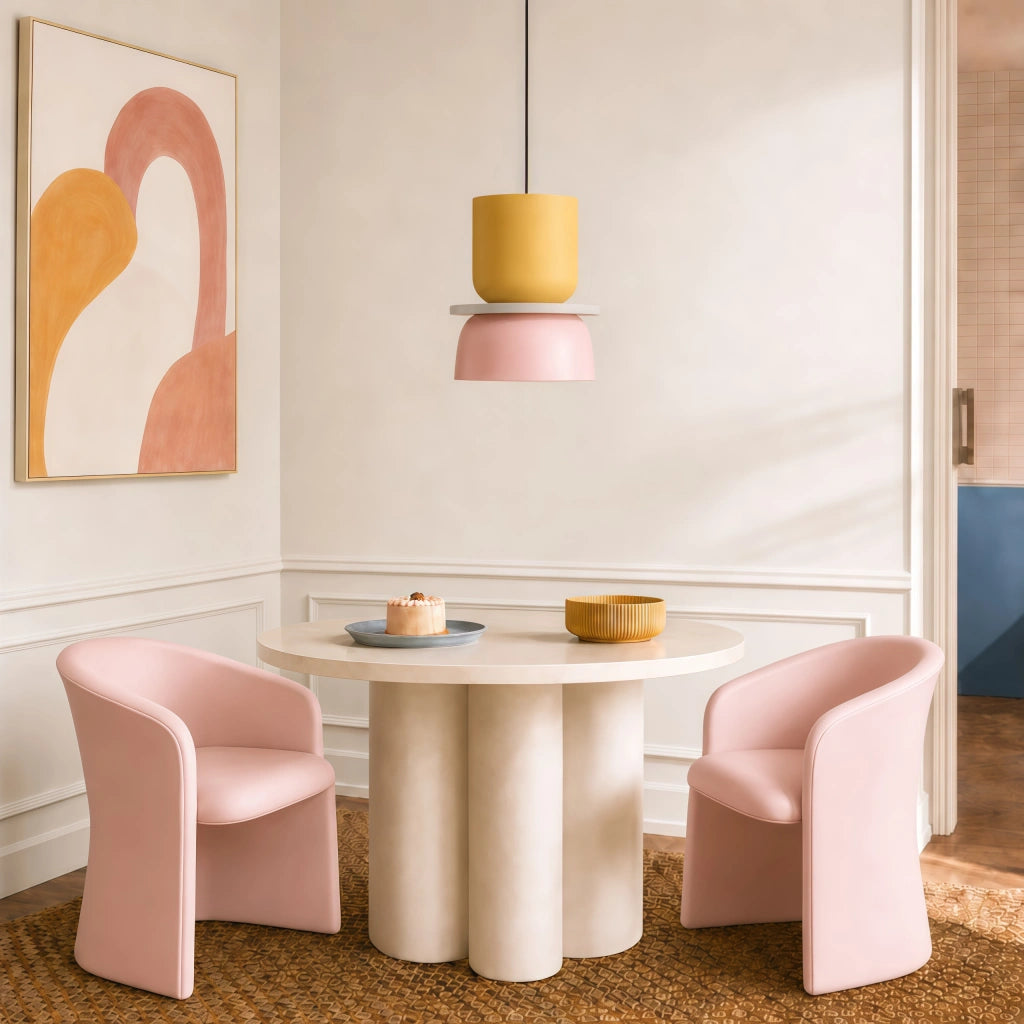 Pink and yellow macaron derq pendant light suspended over a small modern dining table