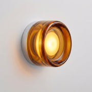 Doxlu amber glass wall sconce, illuminated, hero product shot