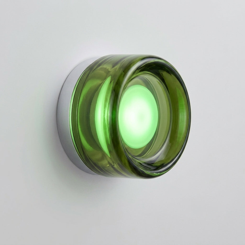 Doxlu green glass wall sconce, front view studio shot, illuminated