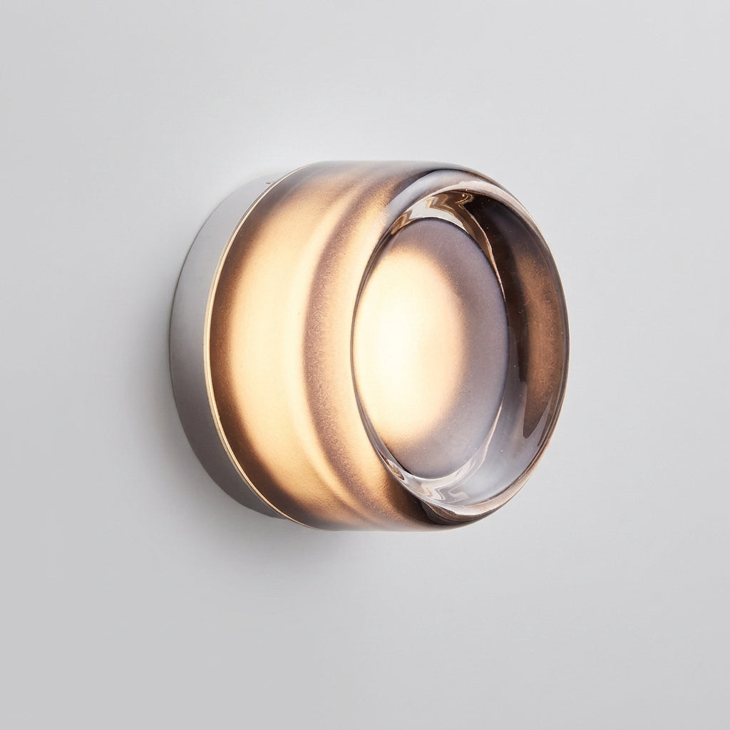 Doxlu grey glass wall sconce, front view studio shot, illuminated