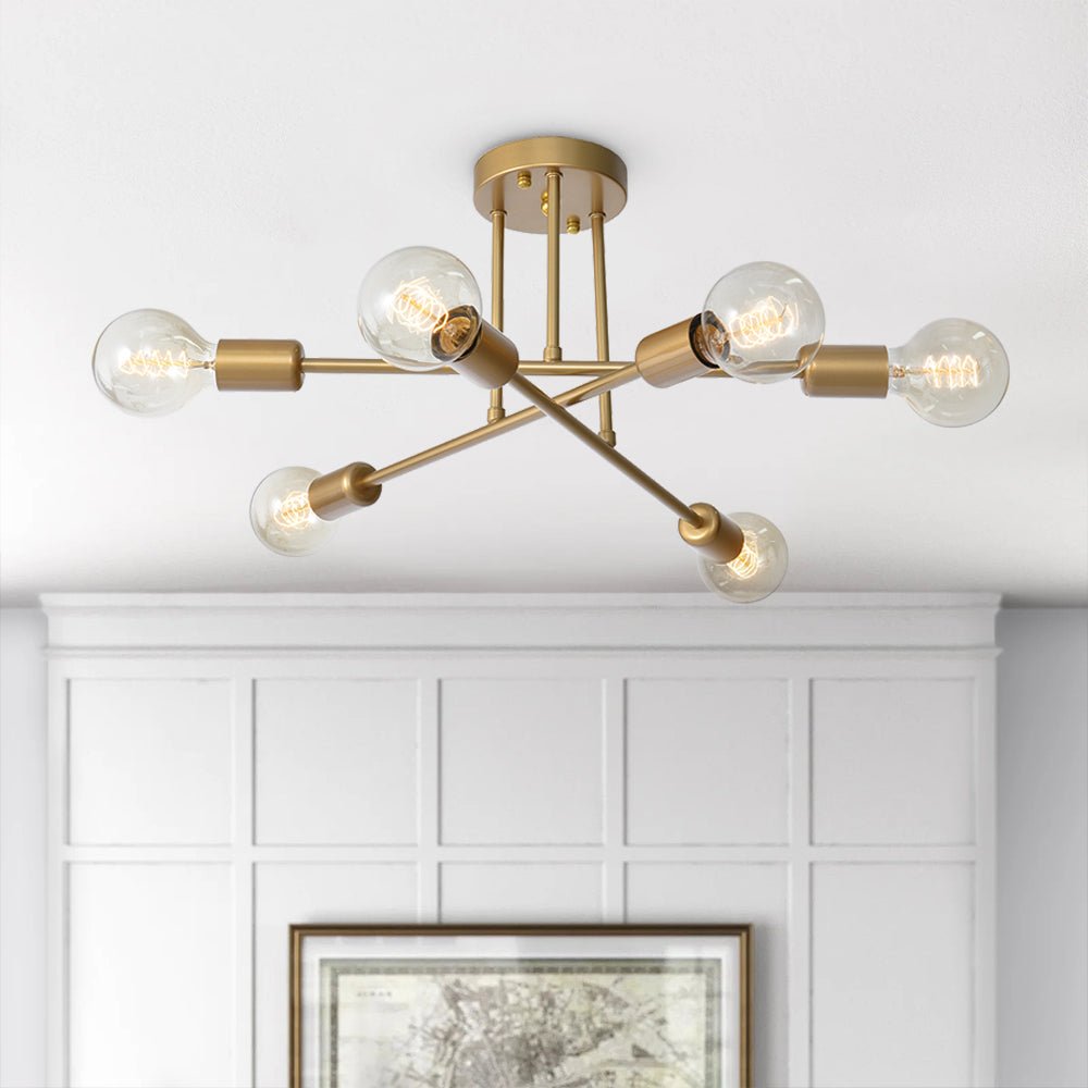 Gold mid-century semi-flush dubce ceiling light with six exposed filament bulbs mounted on a white ceiling