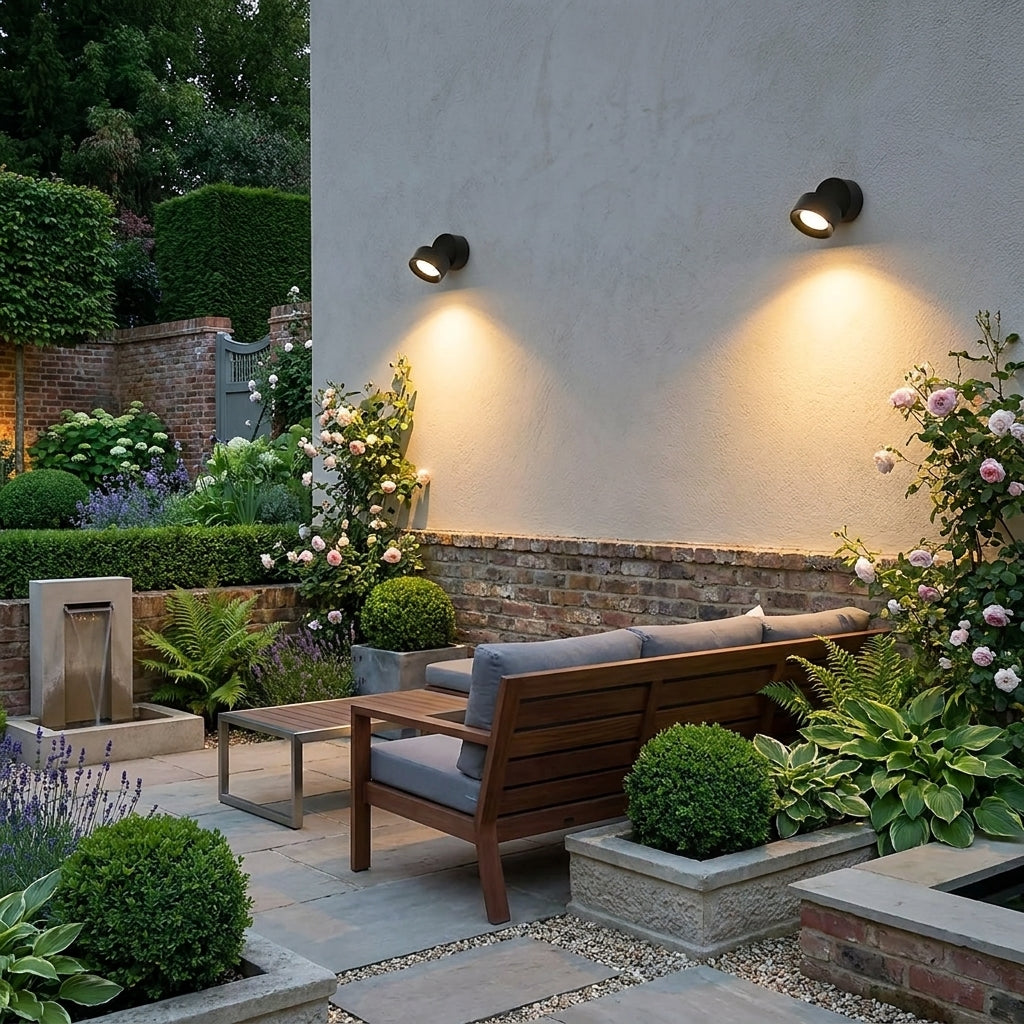 Etsu spotlights on a white rendered wall above a garden patio seating area