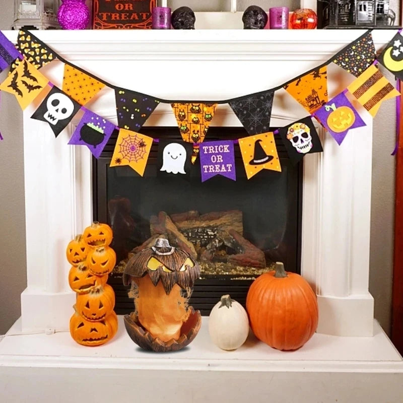 A Halloween-themed bunting banner garland with black, orange, and purple triangular flags, displayed across a white fireplace mantel above pumpkins and decorative items.