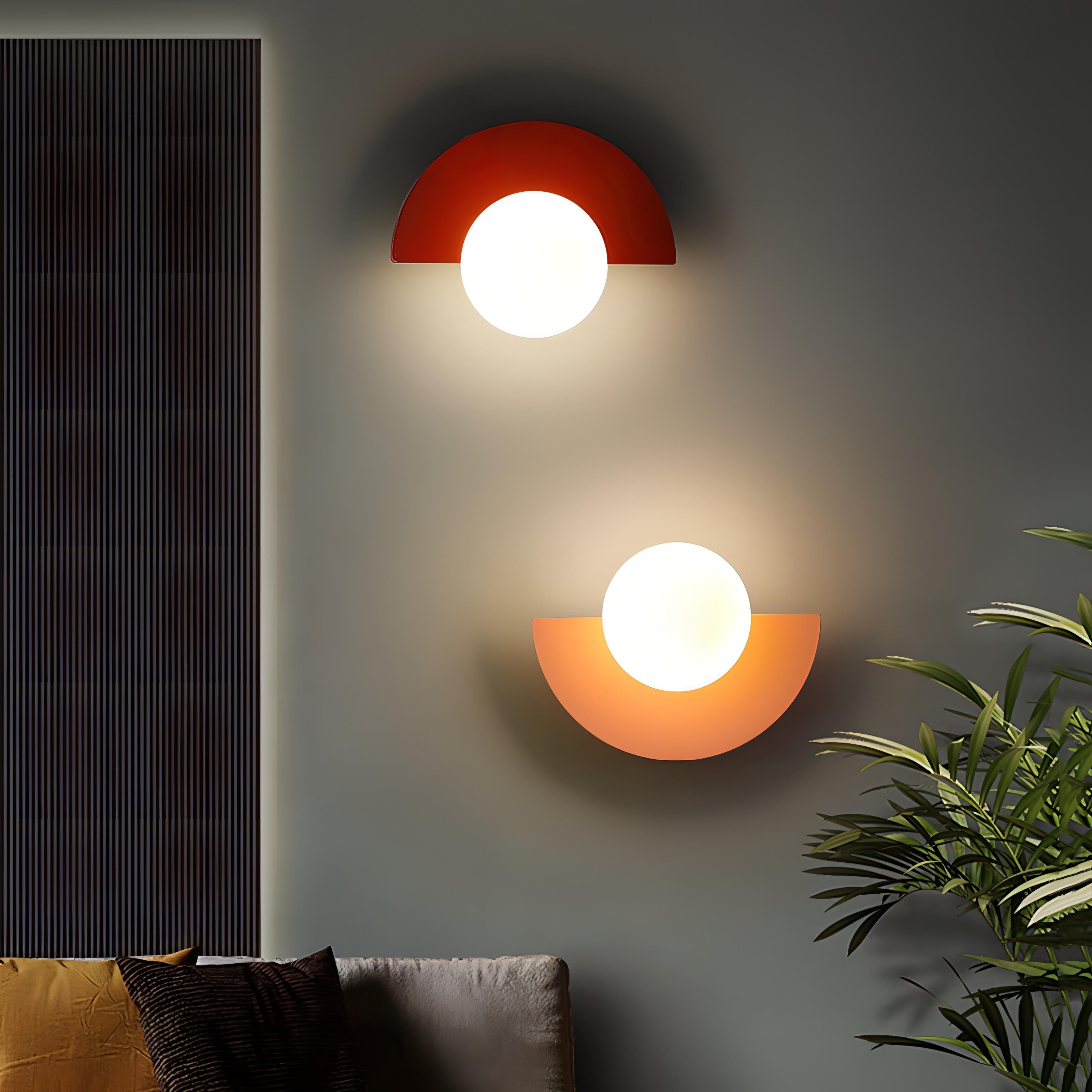 Red and orange Bauhaus-inspired semi-circle fers wall sconces mounted in opposite directions for a playful look