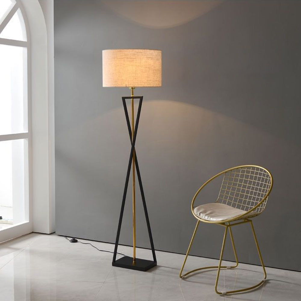 Flaxen beige fabric drum floor lamp adding warm vertical interest to a bright, minimalist reading corner