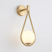 Folzi orb wall light, gold teardrop wall sconce with glass orb shade, illuminated, hero product shot