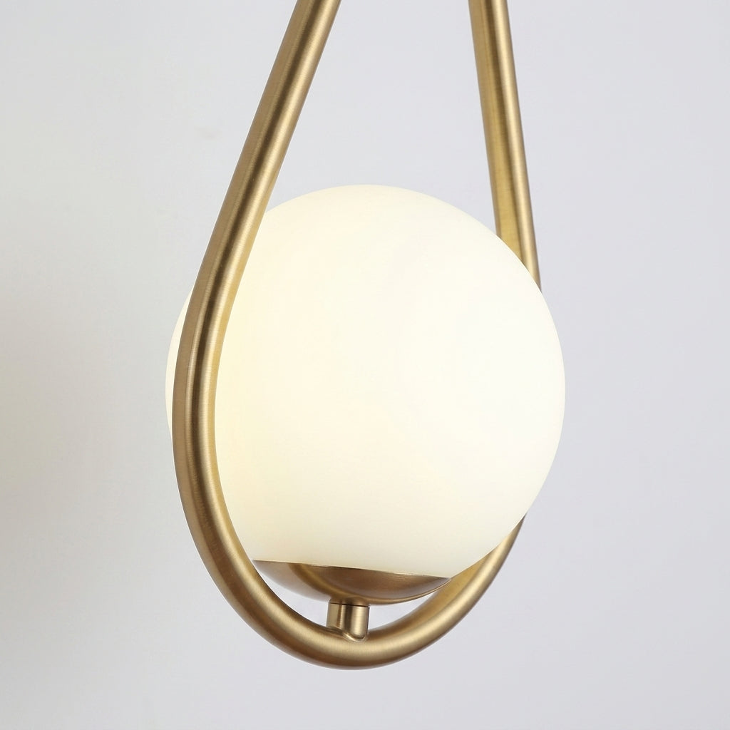 Folzi orb wall light, gold wall sconce, close-up, angled view