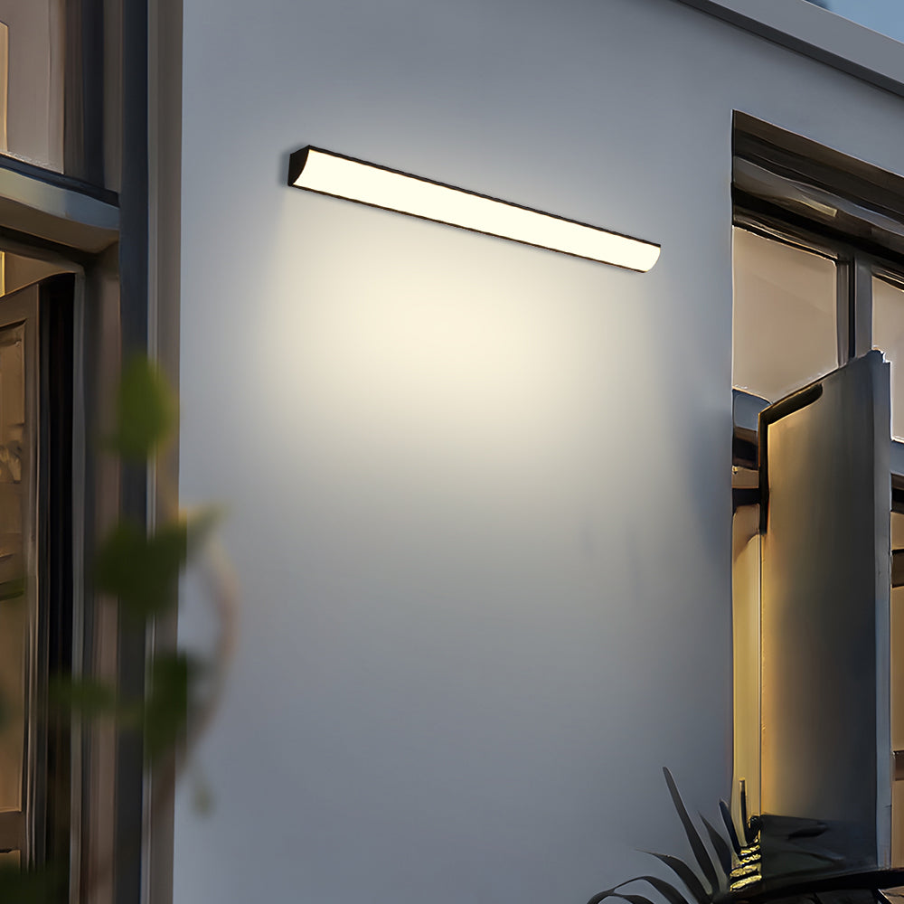 Front-lit exterior linear lamp installed horizontally on a modern patio wall