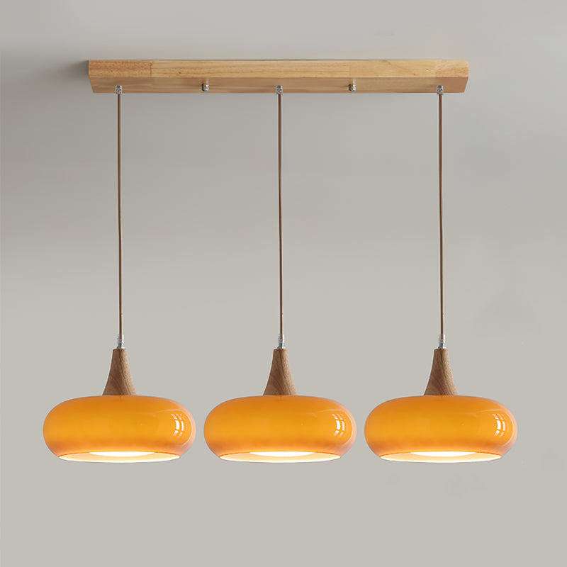 Front view of the 3-head orange linear glass pendant lighting fixture