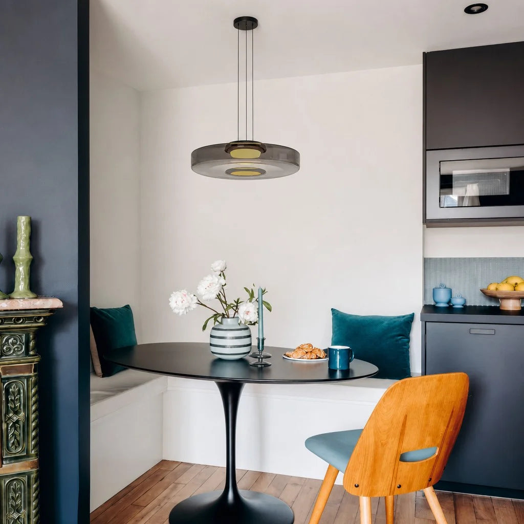 Smoke grey fujs 1-layer glass pendant lamp hanging elegantly above a round black dining table