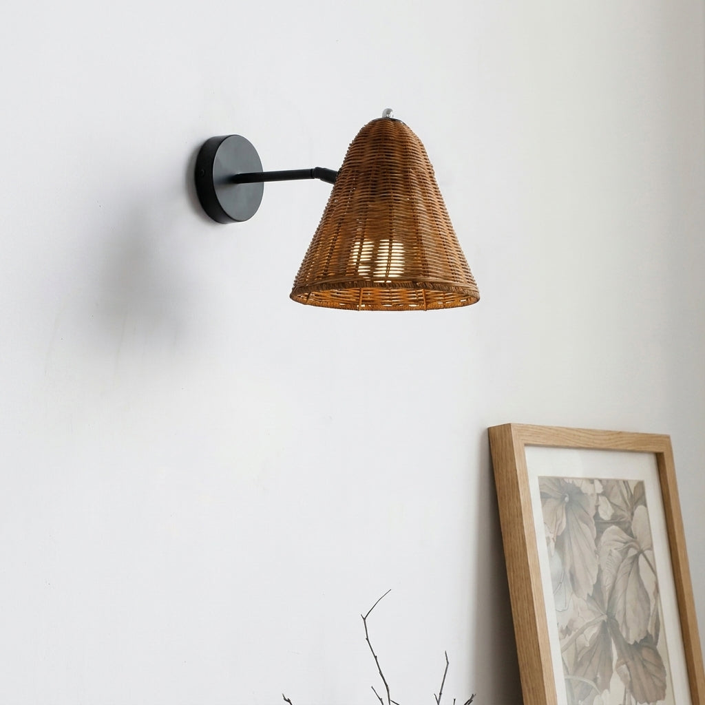 Fumzi rattan woven wall sconce mounted beside framed artwork in a bedroom corner