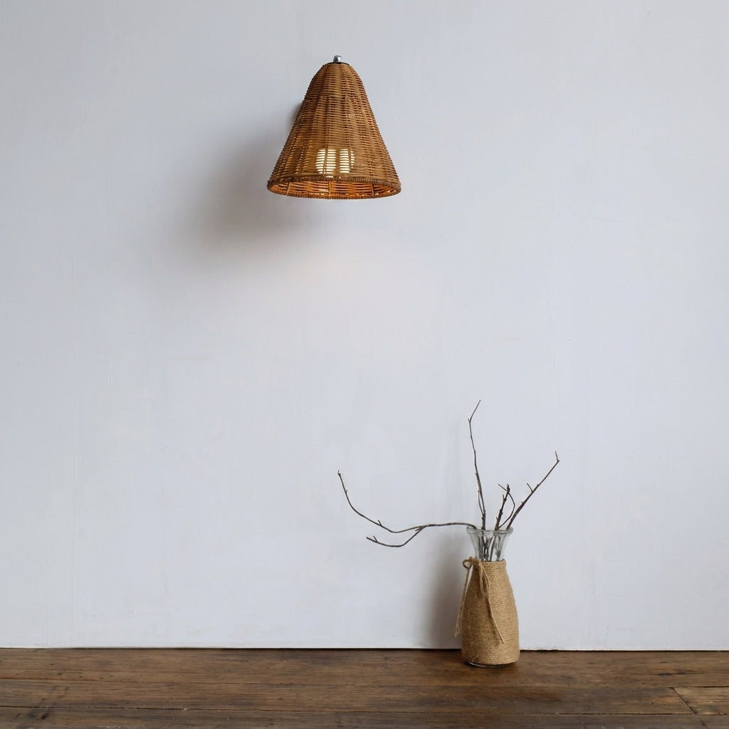 Fumzi Japandi wabi-sabi wall sconce mounted above a console table with a dried branch vase