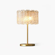 Modern Art Deco solid brass fyns table lamp with a textured moulded glass shade, isolated on a white background