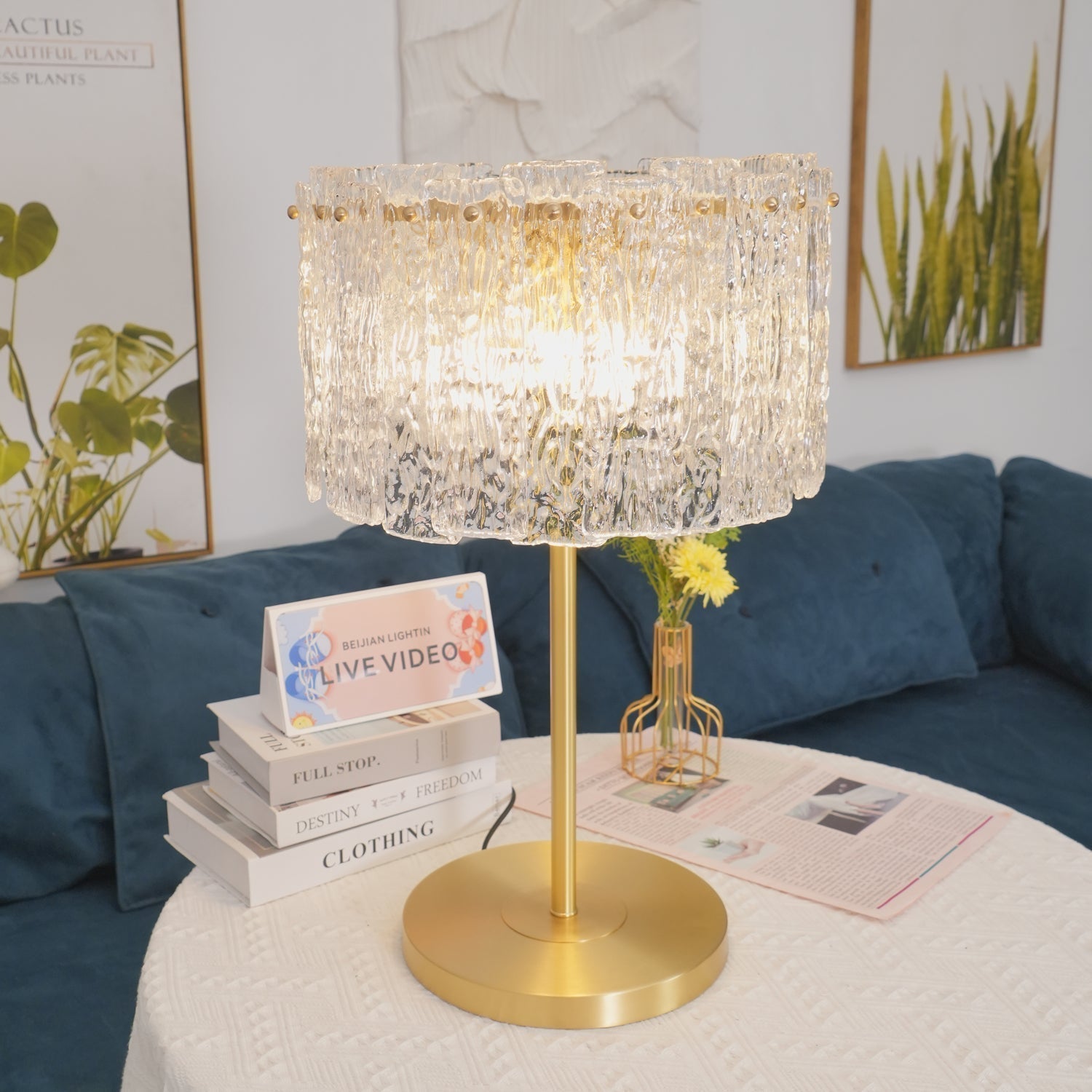 Illuminated textured glass fyns lamp shade refracting warm light over a round white table
