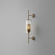 Gexli cylindrical glass wall sconce in bronze finish, angled hero view, lit