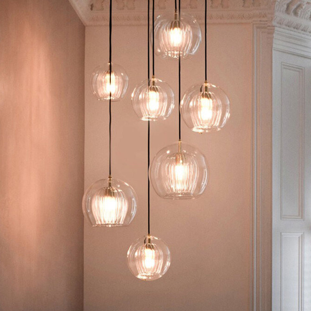 Stunning cascading cluster of clear and amber double-layer glass pendants in a modern hallway