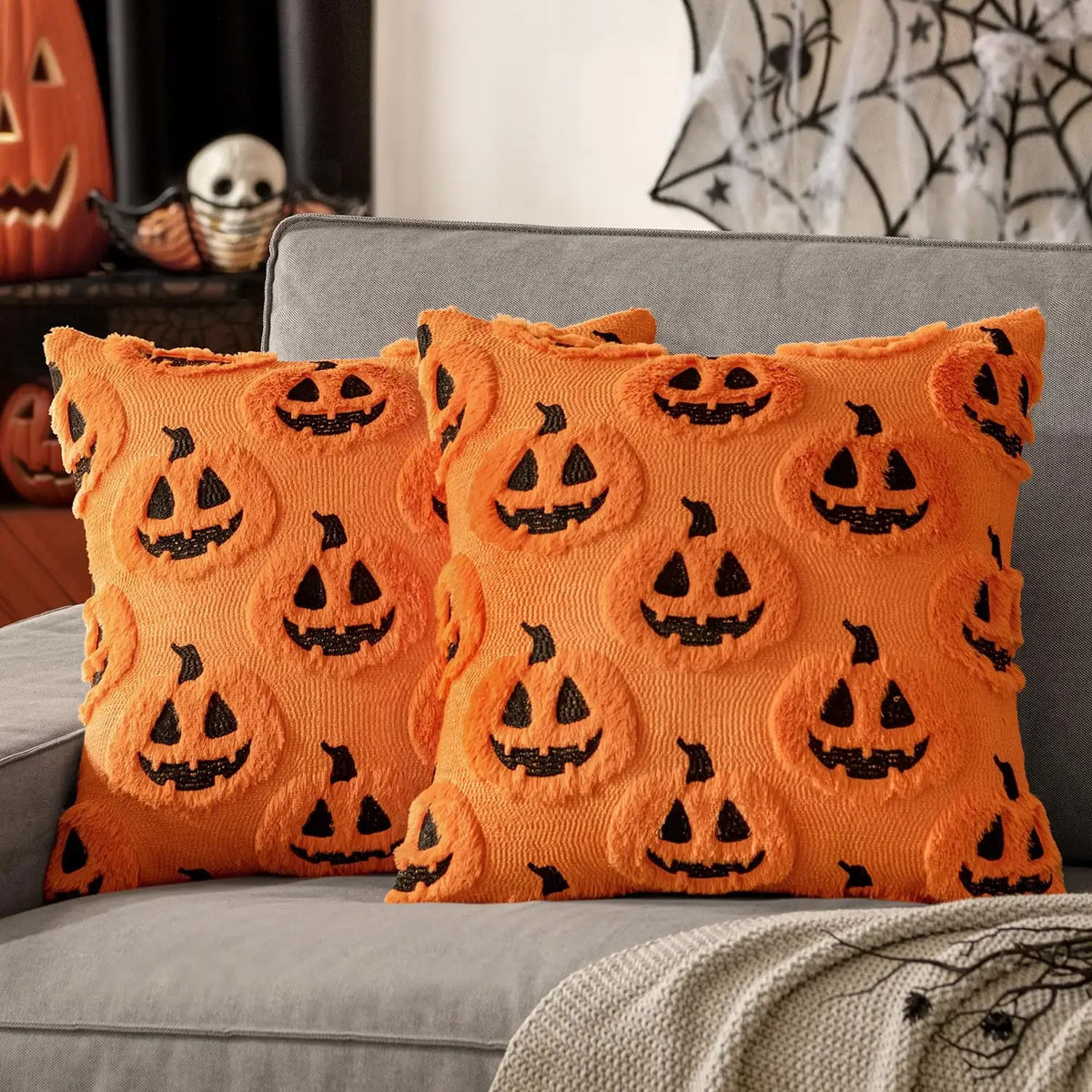 Gloomplush orange jack-o'-lantern Halloween throw pillow cover set of 2 styled on a grey sofa