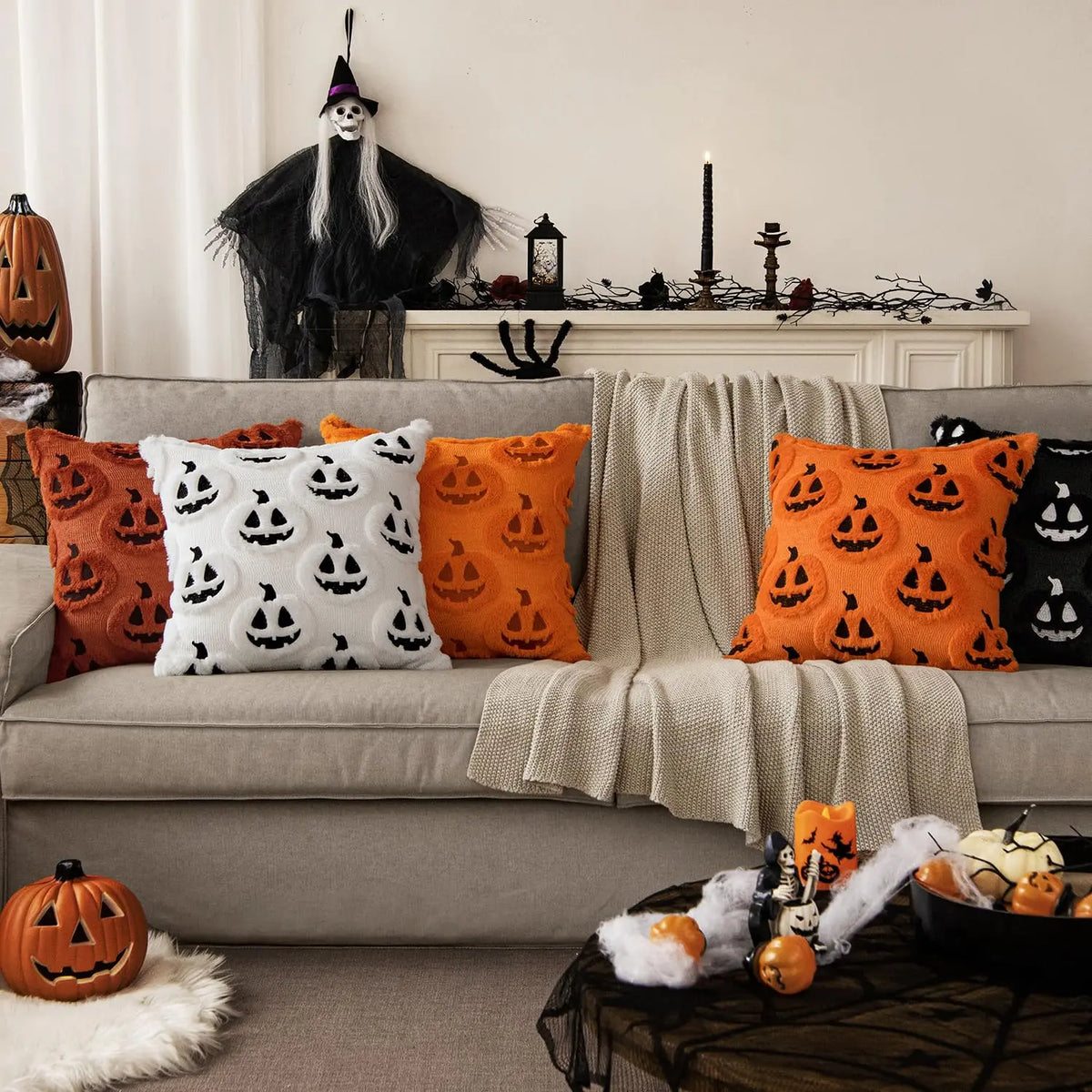 Gloomplush Halloween throw pillow covers in ghost pumpkin, orange, and black jack-o'-lantern styles on a sofa with Halloween mantle decor