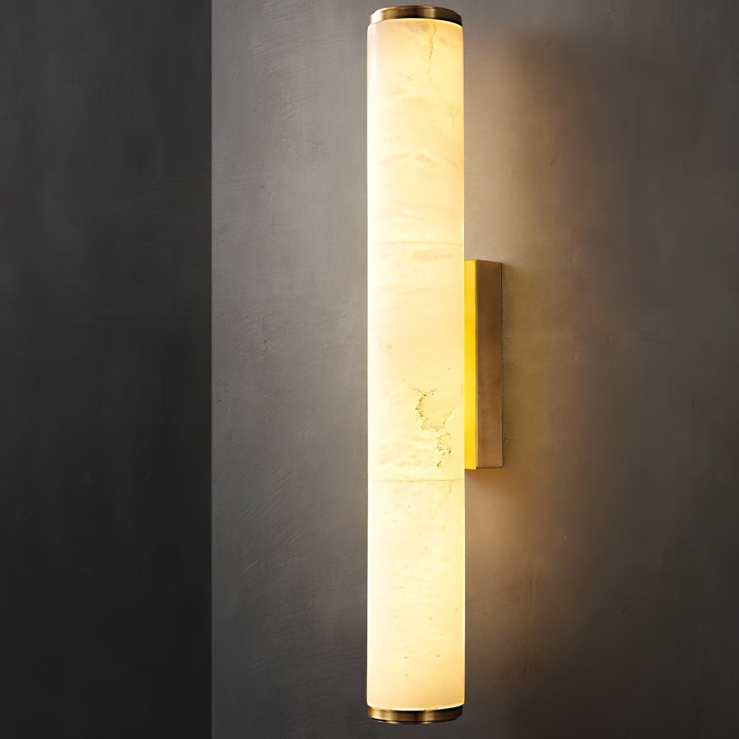 Glowing natural alabaster tube light highlighting its organic stone veining against a dark background