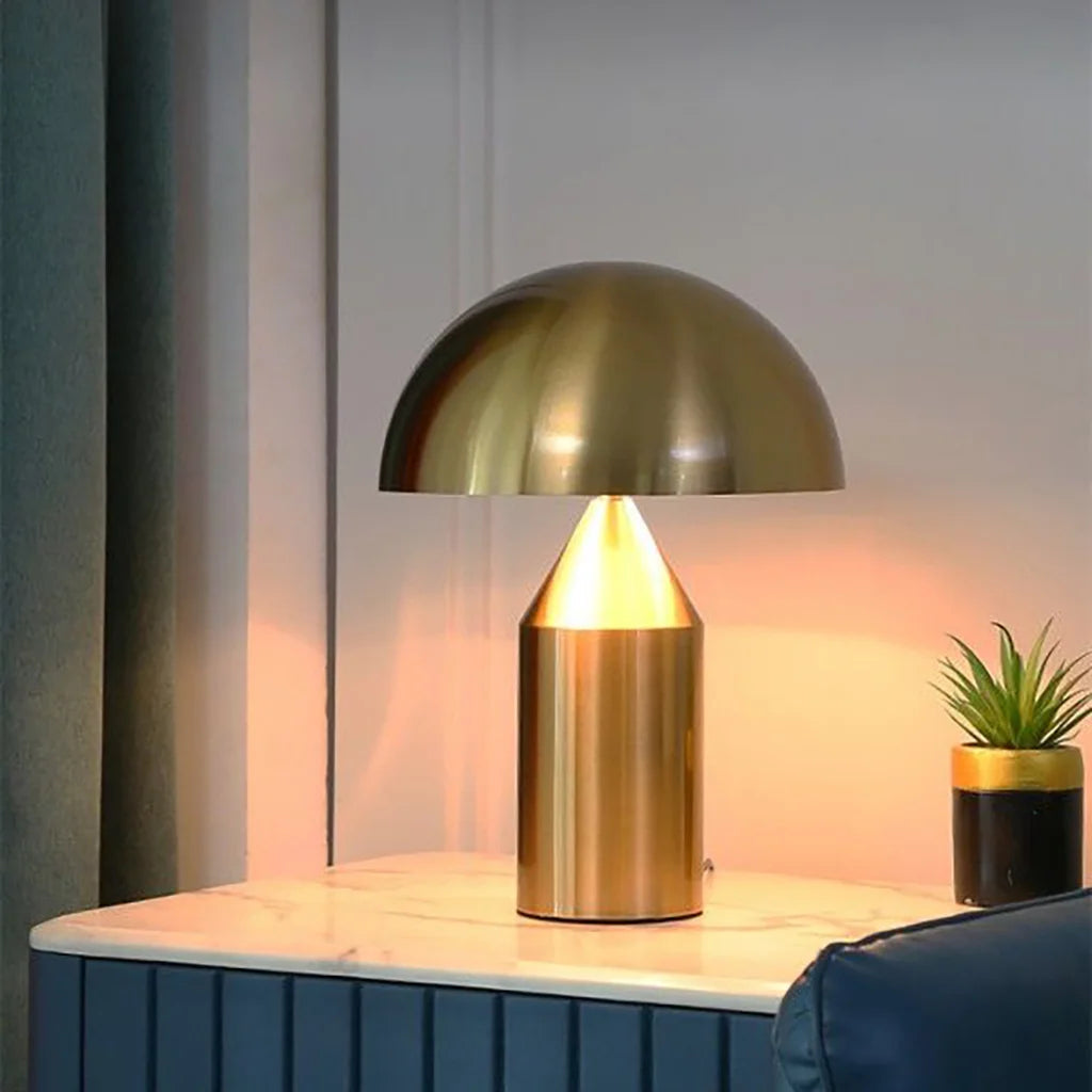 Gold Bauhaus mushroom lamp resting elegantly on a dark blue living room sideboard