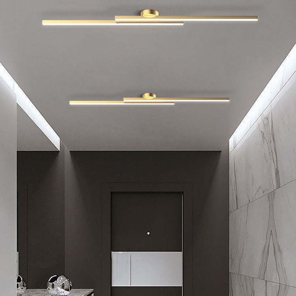Elegant gold double-bar ceiling lamp illuminating a luxurious contemporary hallway
