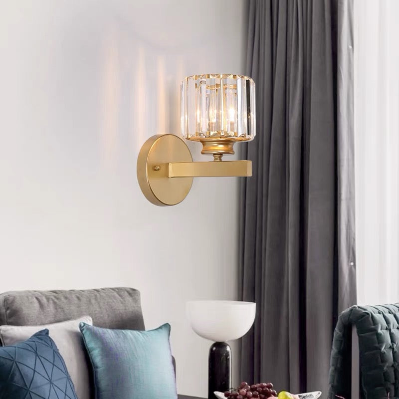 Gold round crystal wall lamp mounted in a modern, naturally lit living space