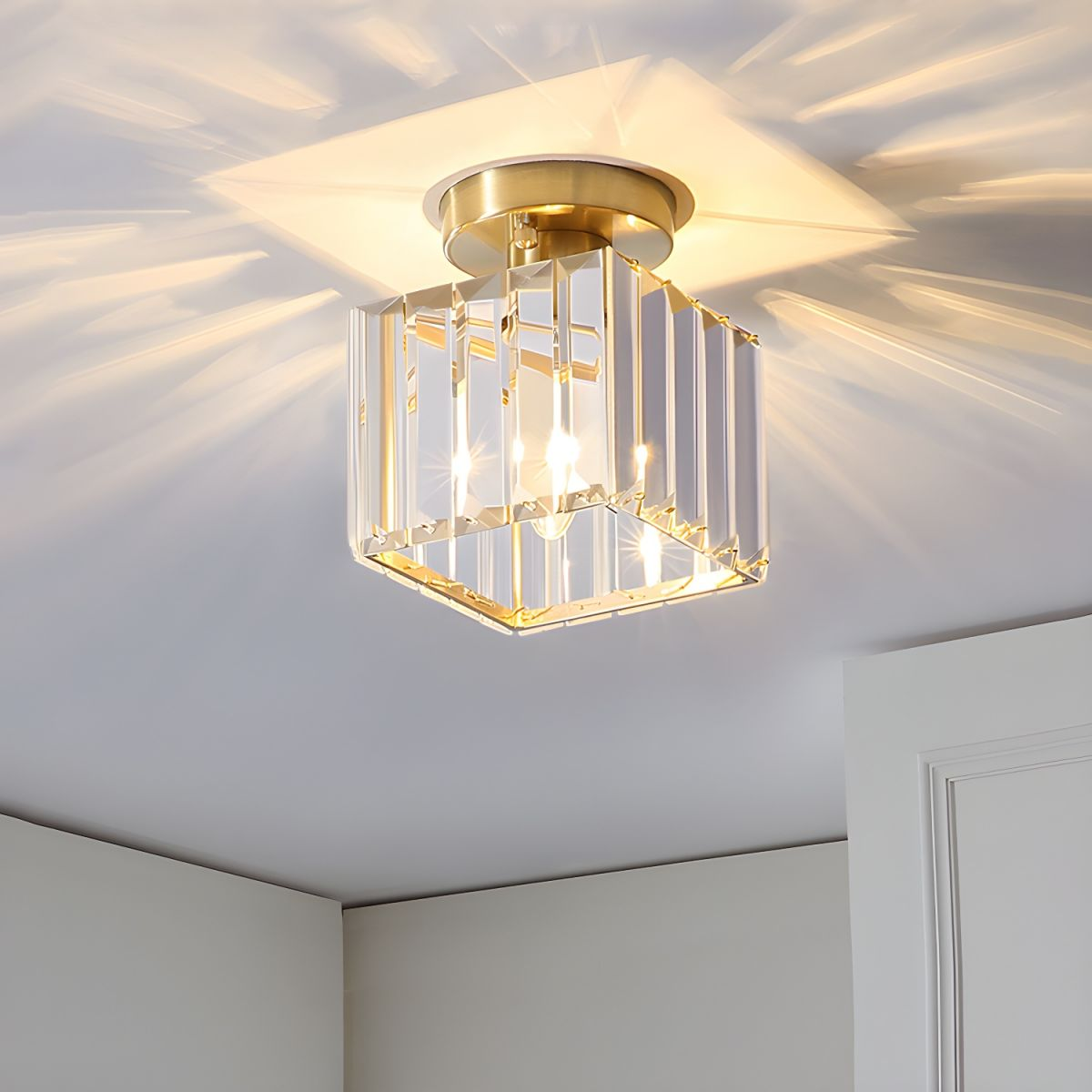 Close-up of the glowing gold square crystal ceiling lamp showing the beautiful light refraction