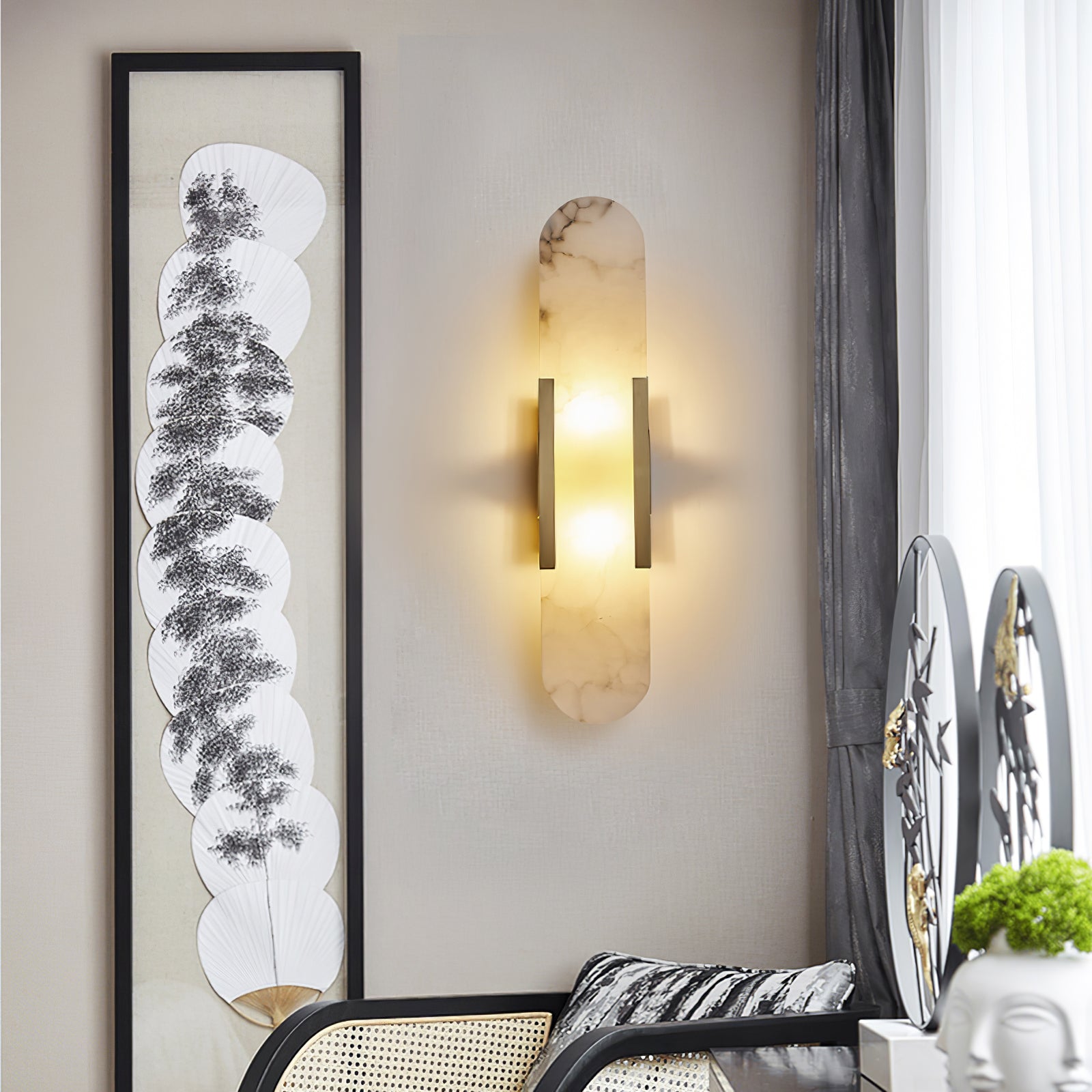 Gold natural stone wall light highlighting contemporary artwork in a stylish living space