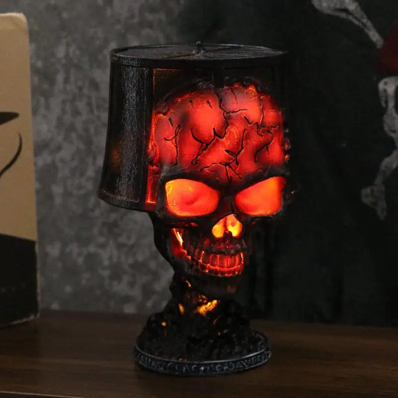 Gorren gothic skull lava lamp lit up on a wooden shelf beside its retail packaging box