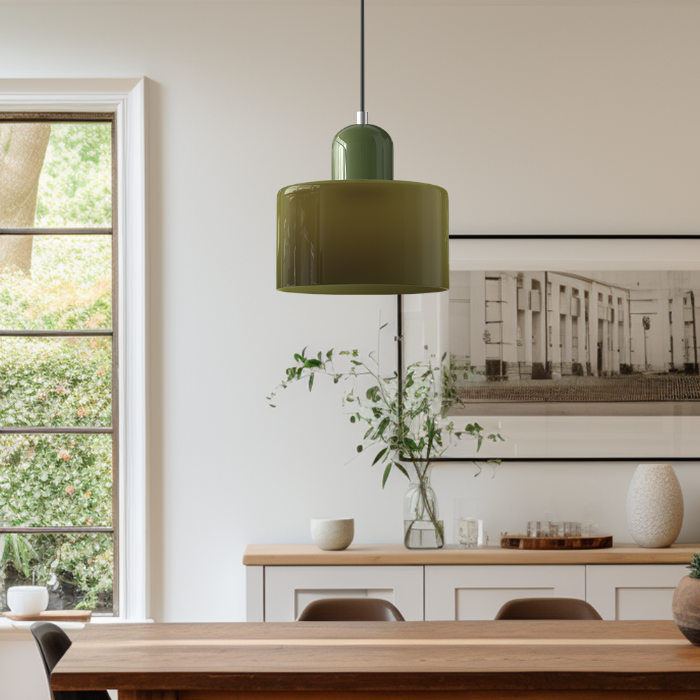 Green Bauhaus glass pendant illuminating a minimalist wooden dining table setup