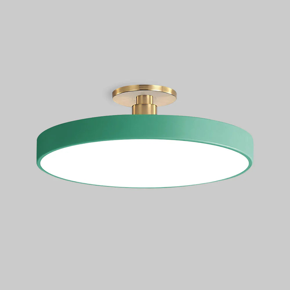 green modern round ceiling lamp isolated against a light grey background