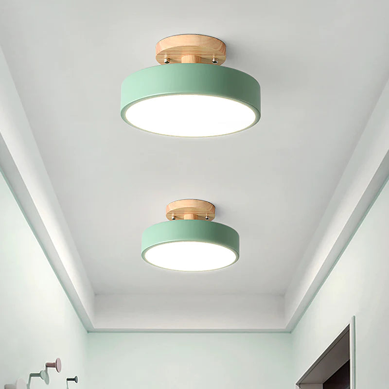 Pair of green pastel ceiling lights illuminating a light green residential corridor
